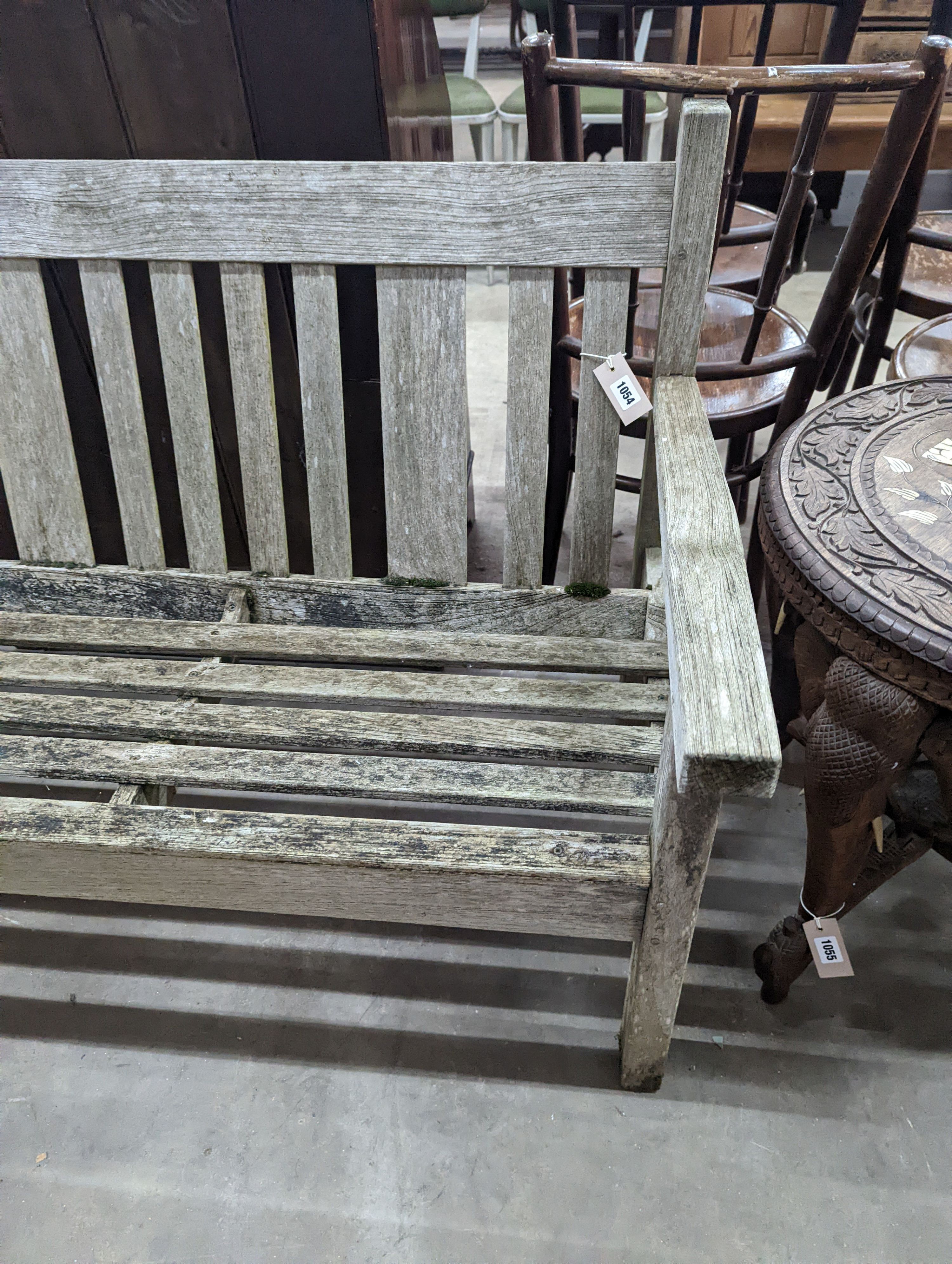 A weathered teak garden bench, length 158cm, depth 62cm, height 84cm